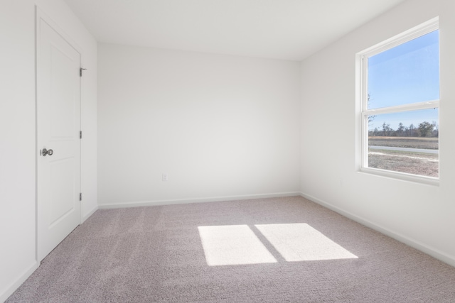 unfurnished bedroom featuring carpet flooring and baseboards