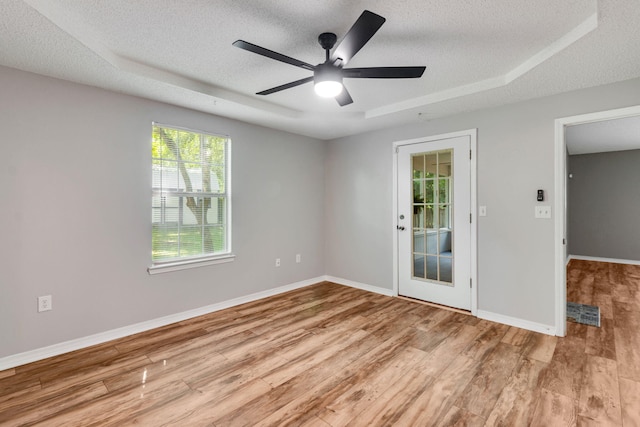 960 Valley Rd, Crestview, FL 32539 - spare room with a textured ceiling, wood finished floors, and a tray ceiling