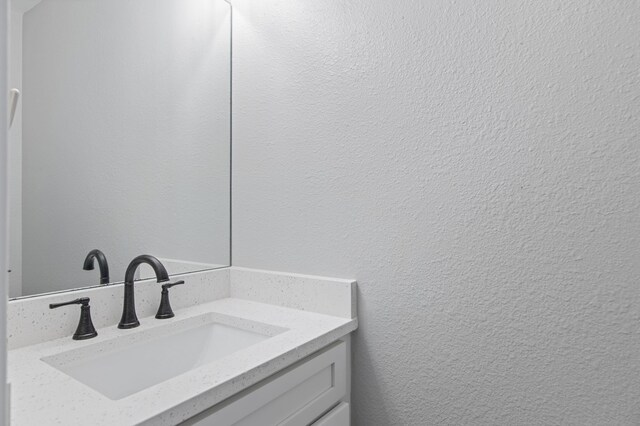 169 Durango Rd, Destin, FL 32541 - bathroom featuring a textured wall and vanity
