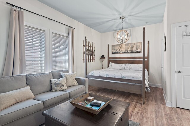 10343 E County Highway 30a Unit B233, Rosemary Beach, FL 32461 - bedroom featuring baseboards, a chandelier, and wood finished floors