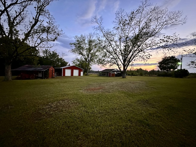 258 Briar Rd, Defuniak Springs, FL 32433 - view of green lawn with a detached garage and an outbuilding