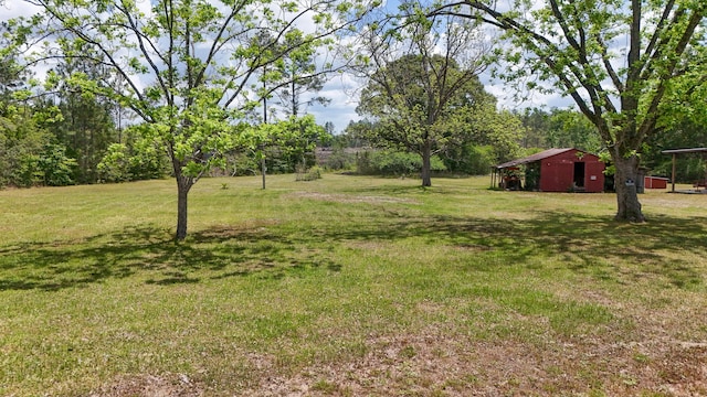 258 Briar Rd, Defuniak Springs, FL 32433 - view of green lawn featuring a pole building and an outdoor structure