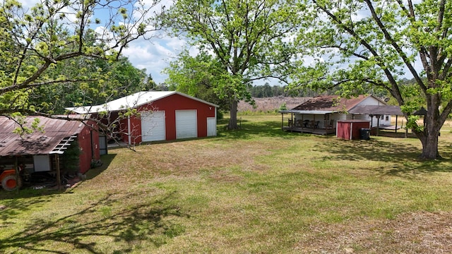 258 Briar Rd, Defuniak Springs, FL 32433 - view of grassy yard featuring an outbuilding, a garage, and a pole building