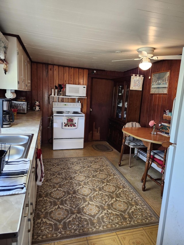 258 Briar Rd, Defuniak Springs, FL 32433 - kitchen featuring white appliances, wood walls, a sink, a ceiling fan, and light countertops