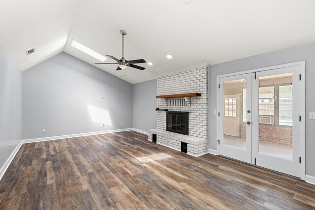 unfurnished living room featuring visible vents, french doors, vaulted ceiling, and wood finished floors