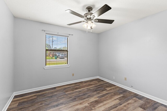 spare room with baseboards, a ceiling fan, and wood finished floors