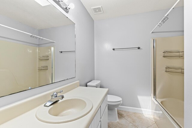 bathroom with vanity, visible vents, toilet, baseboards, and tile patterned floors