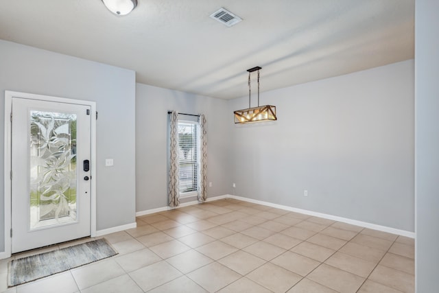 entrance foyer featuring light tile patterned floors, baseboards, a notable chandelier, and visible vents
