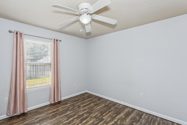 unfurnished room with dark wood-type flooring, baseboards, and ceiling fan