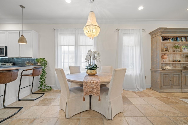 132 Carson Oaks Ln, Santa Rosa Beach, FL 32459 - dining room featuring baseboards, stone tile floors, crown molding, and a chandelier