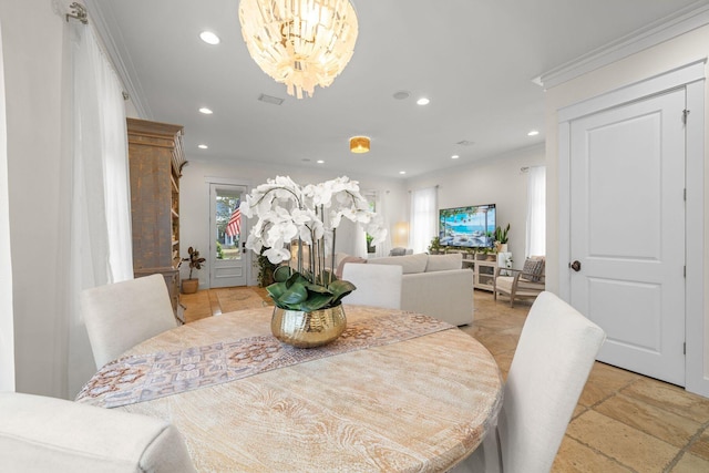 132 Carson Oaks Ln, Santa Rosa Beach, FL 32459 - dining space featuring crown molding, stone tile floors, recessed lighting, and a notable chandelier