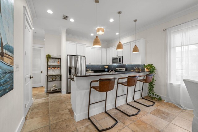 132 Carson Oaks Ln, Santa Rosa Beach, FL 32459 - kitchen with stone tile floors, decorative backsplash, dark countertops, white cabinets, and stainless steel appliances