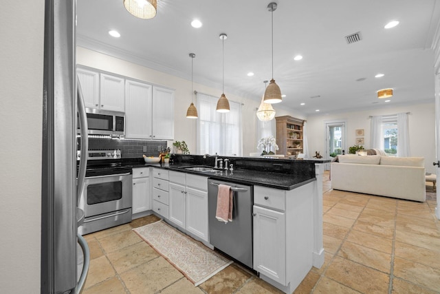 132 Carson Oaks Ln, Santa Rosa Beach, FL 32459 - kitchen with stone tile floors, a peninsula, open floor plan, recessed lighting, and appliances with stainless steel finishes