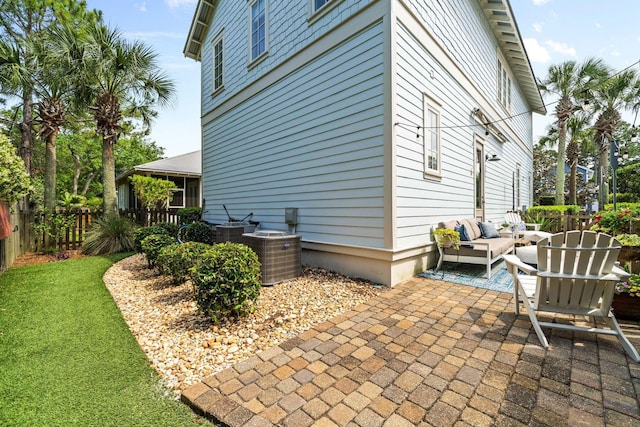 132 Carson Oaks Ln, Santa Rosa Beach, FL 32459 - view of property exterior featuring central air condition unit, fence, outdoor lounge area, and a patio area