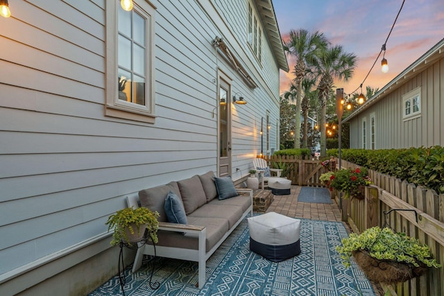 132 Carson Oaks Ln, Santa Rosa Beach, FL 32459 - patio terrace at dusk with fence and an outdoor living space