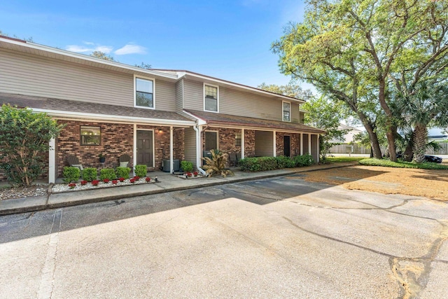 229 Carmel Dr Unit 4, Fort Walton Beach, FL 32547 - traditional-style house with brick siding and a porch