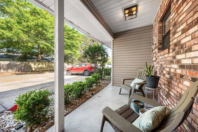 229 Carmel Dr Unit 4, Fort Walton Beach, FL 32547 - view of patio featuring a porch and fence