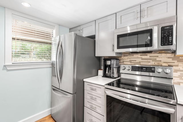 229 Carmel Dr Unit 4, Fort Walton Beach, FL 32547 - kitchen with appliances with stainless steel finishes, tasteful backsplash, light countertops, and baseboards