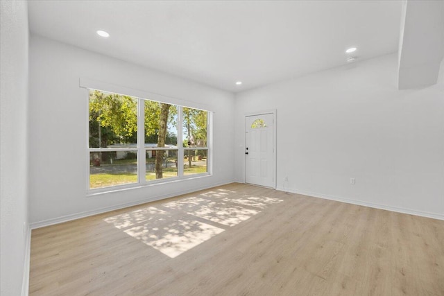 unfurnished room featuring baseboards, recessed lighting, and wood finished floors