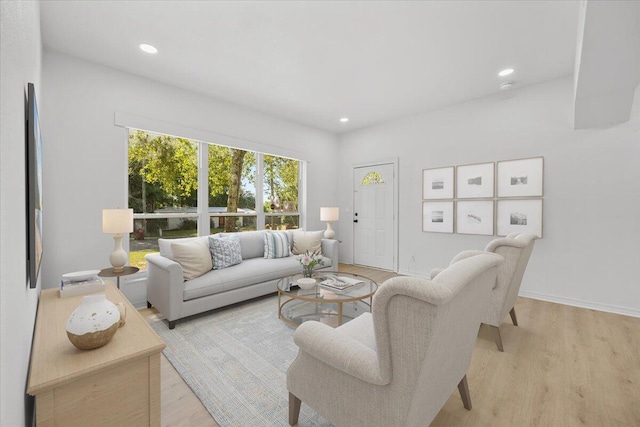 living area featuring recessed lighting, light wood-style flooring, and baseboards