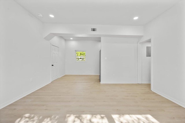 empty room with recessed lighting, baseboards, visible vents, and light wood-style floors