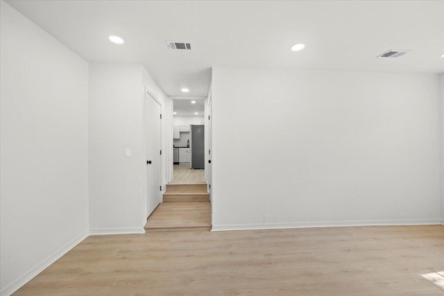 unfurnished room with visible vents, recessed lighting, and light wood-style floors