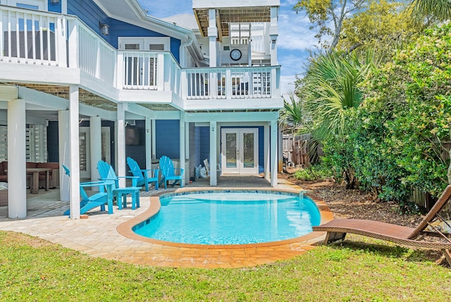rear view of property with a patio, fence, french doors, and an outdoor pool