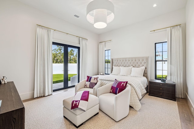bedroom featuring baseboards, access to outside, and visible vents
