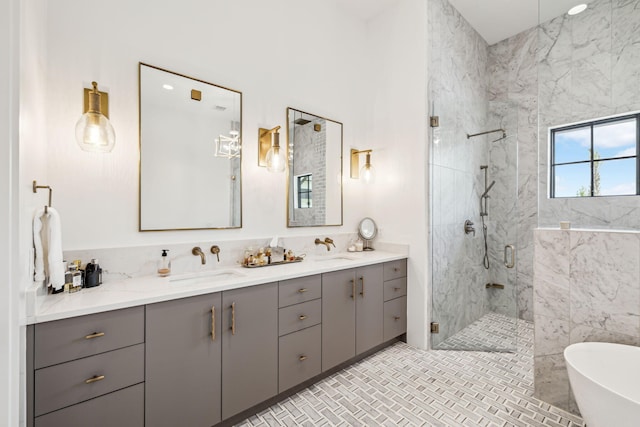 bathroom featuring a sink, a marble finish shower, a soaking tub, and double vanity