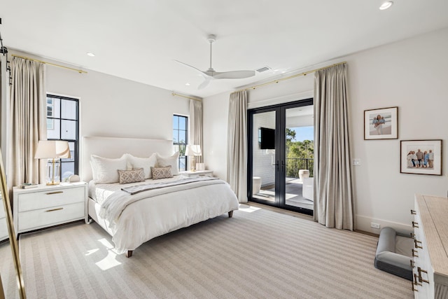 bedroom featuring visible vents, light colored carpet, multiple windows, and access to exterior
