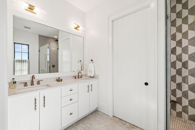 full bathroom with a sink, a shower stall, double vanity, and visible vents