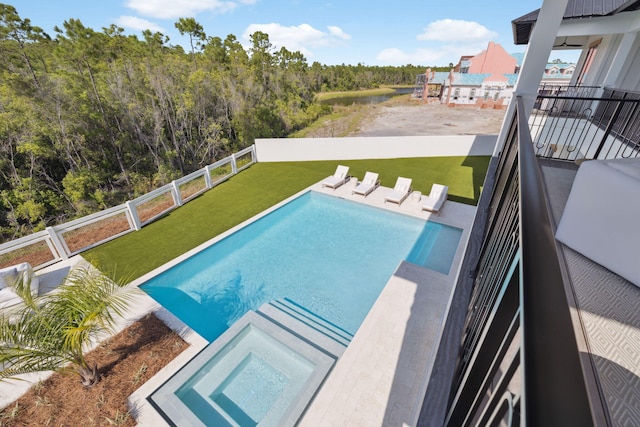 view of swimming pool featuring an in ground hot tub, a fenced in pool, fence, a yard, and a water view