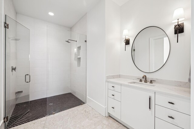 full bathroom featuring vanity, a shower stall, and recessed lighting