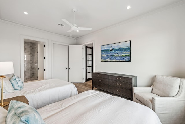 bedroom with visible vents, ornamental molding, wood finished floors, recessed lighting, and connected bathroom
