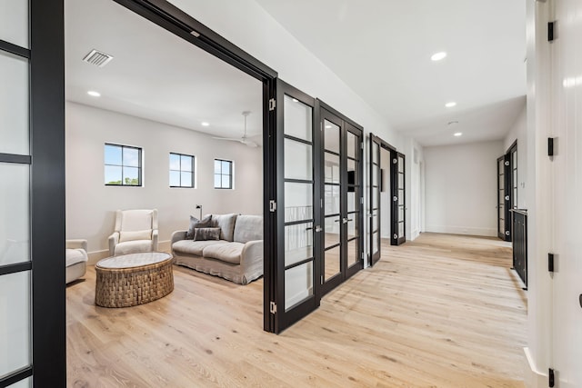 hallway with french doors, recessed lighting, wood finished floors, and visible vents