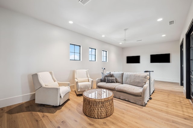 living area featuring recessed lighting, baseboards, visible vents, and light wood-style floors