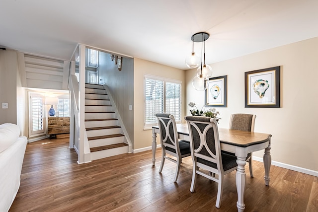 dining room with stairway, wood finished floors, and a wealth of natural light
