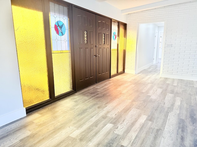2710 Rutgers Dr, Panama City, FL 32405 - entrance foyer with light wood-style floors, baseboards, and brick wall