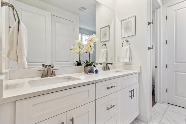 full bath with double vanity, visible vents, a sink, and marble finish floor
