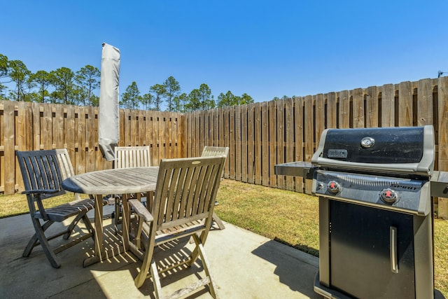 view of patio / terrace with fence, outdoor dining space, and area for grilling