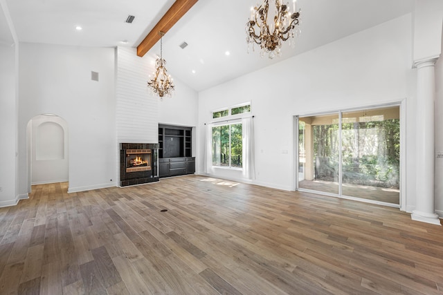 2928 Pine Valley Dr, Miramar Beach, FL 32550 - unfurnished living room featuring wood finished floors, beam ceiling, a chandelier, and high vaulted ceiling