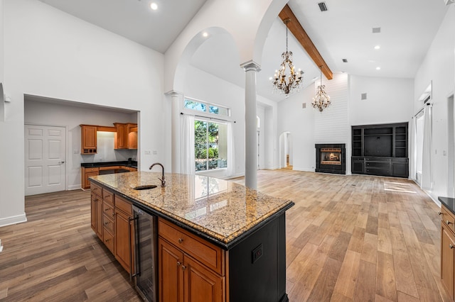 2928 Pine Valley Dr, Miramar Beach, FL 32550 - kitchen featuring high vaulted ceiling, a sink, light wood-style floors, and wine cooler