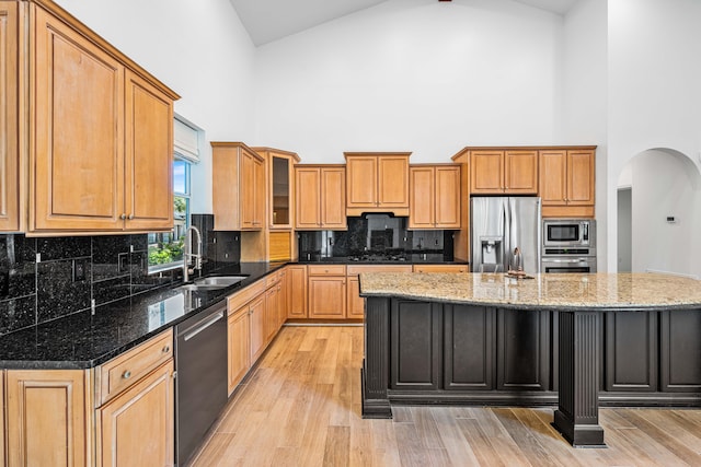 2928 Pine Valley Dr, Miramar Beach, FL 32550 - kitchen with high vaulted ceiling, appliances with stainless steel finishes, a sink, and a center island