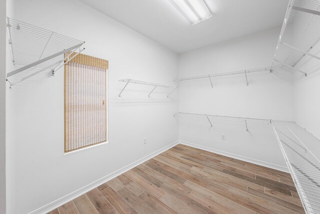 2928 Pine Valley Dr, Miramar Beach, FL 32550 - walk in closet with wood finished floors