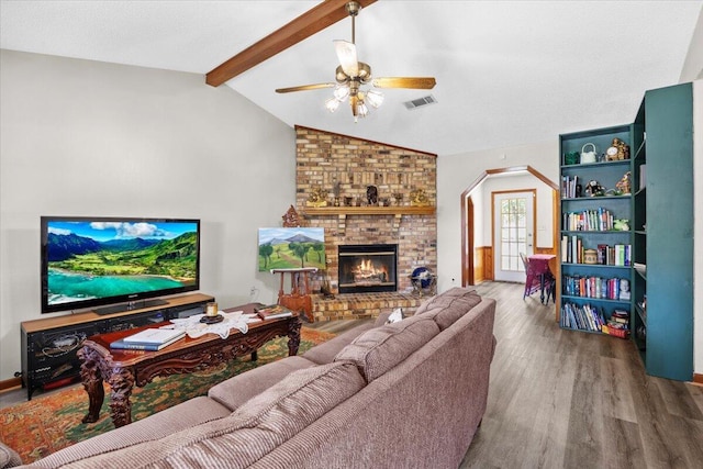612 Moss Dr, Crestview, FL 32536 - living area featuring a ceiling fan, visible vents, arched walkways, wood finished floors, and lofted ceiling with beams