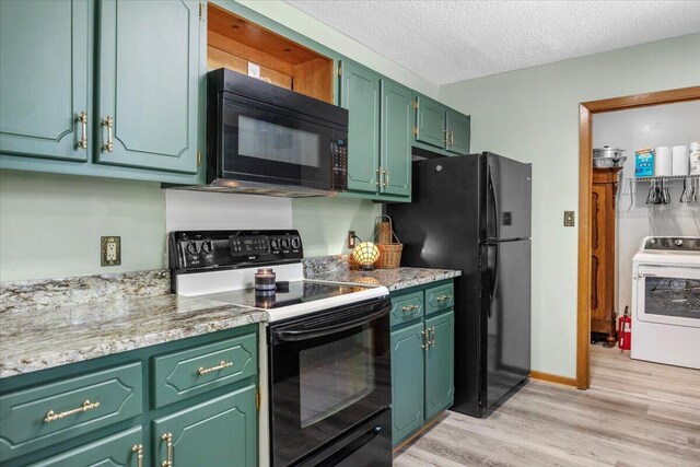 612 Moss Dr, Crestview, FL 32536 - kitchen featuring a textured ceiling, washer / dryer, light wood-type flooring, black appliances, and green cabinets