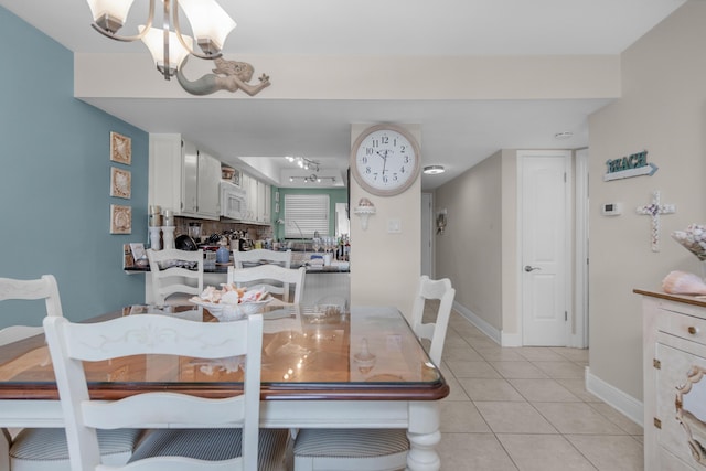 909 Santa Rosa Blvd Unit 241, Fort Walton Beach, FL 32548 - dining space featuring baseboards, light tile patterned floors, and a notable chandelier