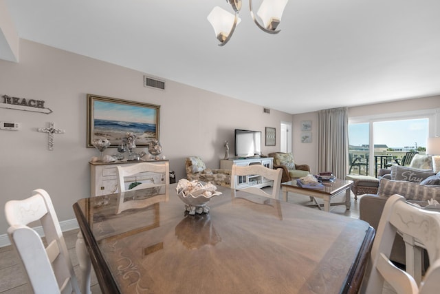 909 Santa Rosa Blvd Unit 241, Fort Walton Beach, FL 32548 - dining room featuring an inviting chandelier, baseboards, and visible vents