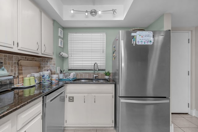 909 Santa Rosa Blvd Unit 241, Fort Walton Beach, FL 32548 - kitchen featuring decorative backsplash, a raised ceiling, a sink, light tile patterned floors, and stainless steel appliances