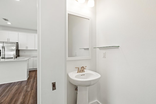 bathroom featuring wood finished floors and a sink